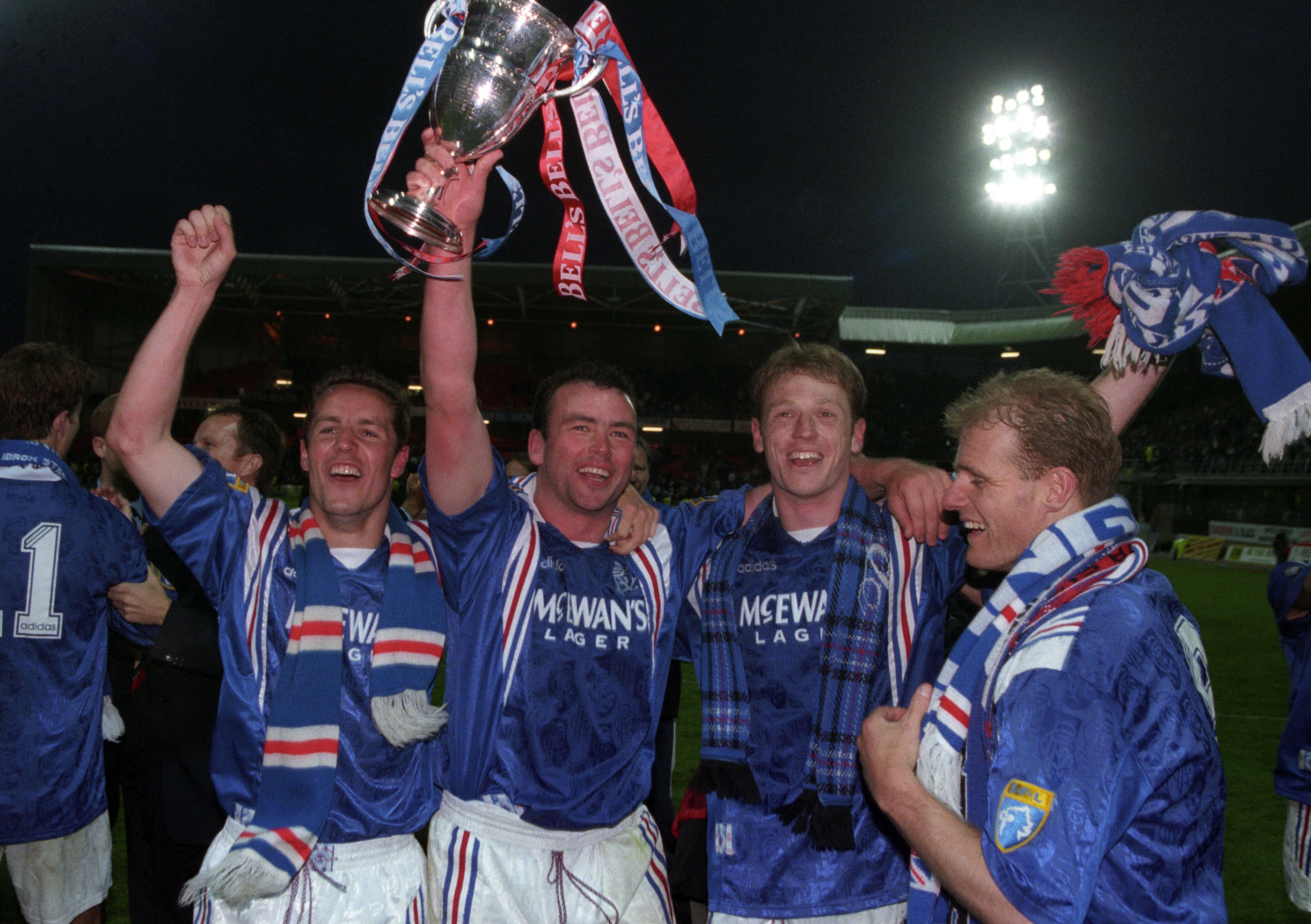 Rangers players celebrate after winning a ninth Scottish Premier League title in a row in May 1997.