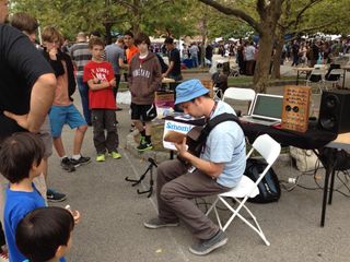 A musician demonstrates his homemade "Smomid," which stands for "String Modeling Midi Device" at World Maker Faire in New York on Sept. 21, 2013.