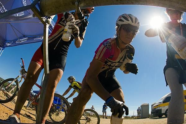 The Trek VW WSD women grab some more liquid on a hot stage.