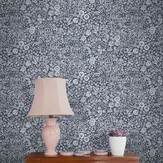 blue floral designed wallpaper pink lamp white pot