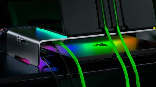 Razer Monitor Stand Chroma, an ergonomic monitor stand and USB-C hub combo with Chroma RGB lighting shot from behind.