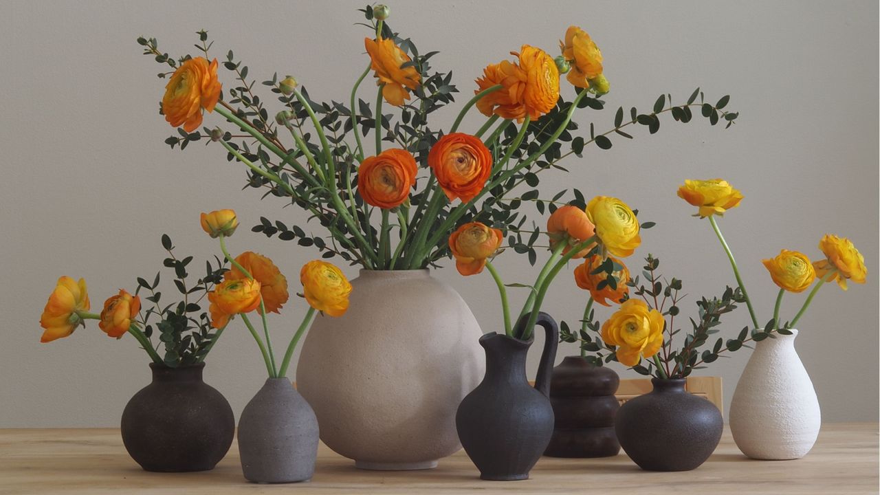 a series of vases with orange ranunculi 