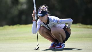 Team USA's Nelly Korda crouches down to check the green ahead of the 2024 Olympic golf event at the Paris Games.