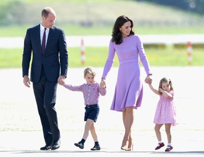The Duke And Duchess Of Cambridge Visit Germany - Day 3 HAMBURG, GERMANY - JULY 21: Prince William, Duke of Cambridge, Catherine, Duchess of Cambridge, Prince George of Cambridge and Princess Charlotte of Cambridge view helicopter models H145 and H135 before departing from Hamburg airport on the last day of their official visit to Poland and Germany on July 21, 2017 in Hamburg, Germany. (Photo by Samir Hussein/Samir Hussein/WireImage)