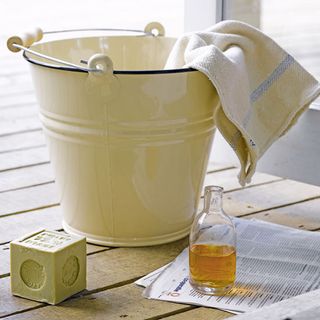 spring cleaning with bucket and cleaning napkin