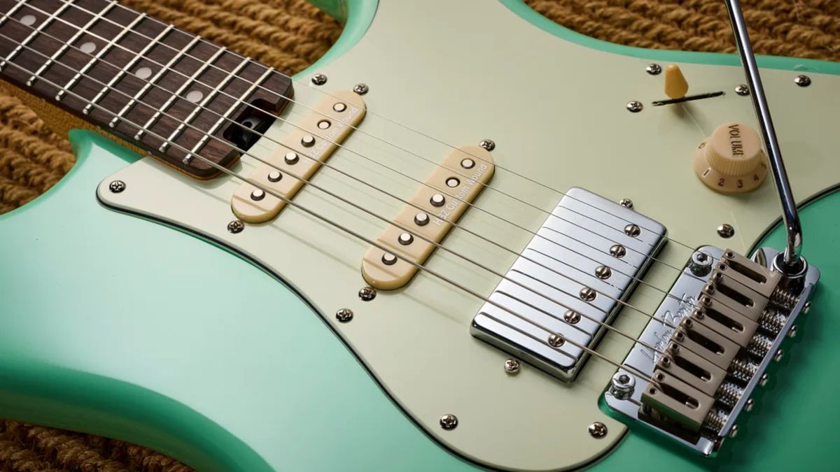 A close-up photograph of the Harley Benton ST-Modern electric guitar in green and cream showing the strings and pickups.