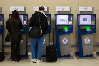 Participants in the Global Entry program use U.S. Customs kiosks at an airport. Credit: U.S. Customs and Border Protection