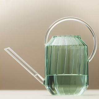 green glass watering can