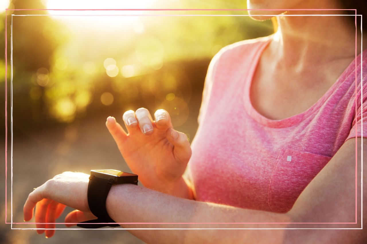 A close up of a woman looking at how many calories burned on her smart watch