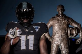 The UCF Knights Oct. 14, 2017 ”Space Game" uniform is modeled in front of the statue of first astronaut Alan Shepard at the U.S. Astronaut Hall of Fame at Kennedy Space Center Visitor Complex.