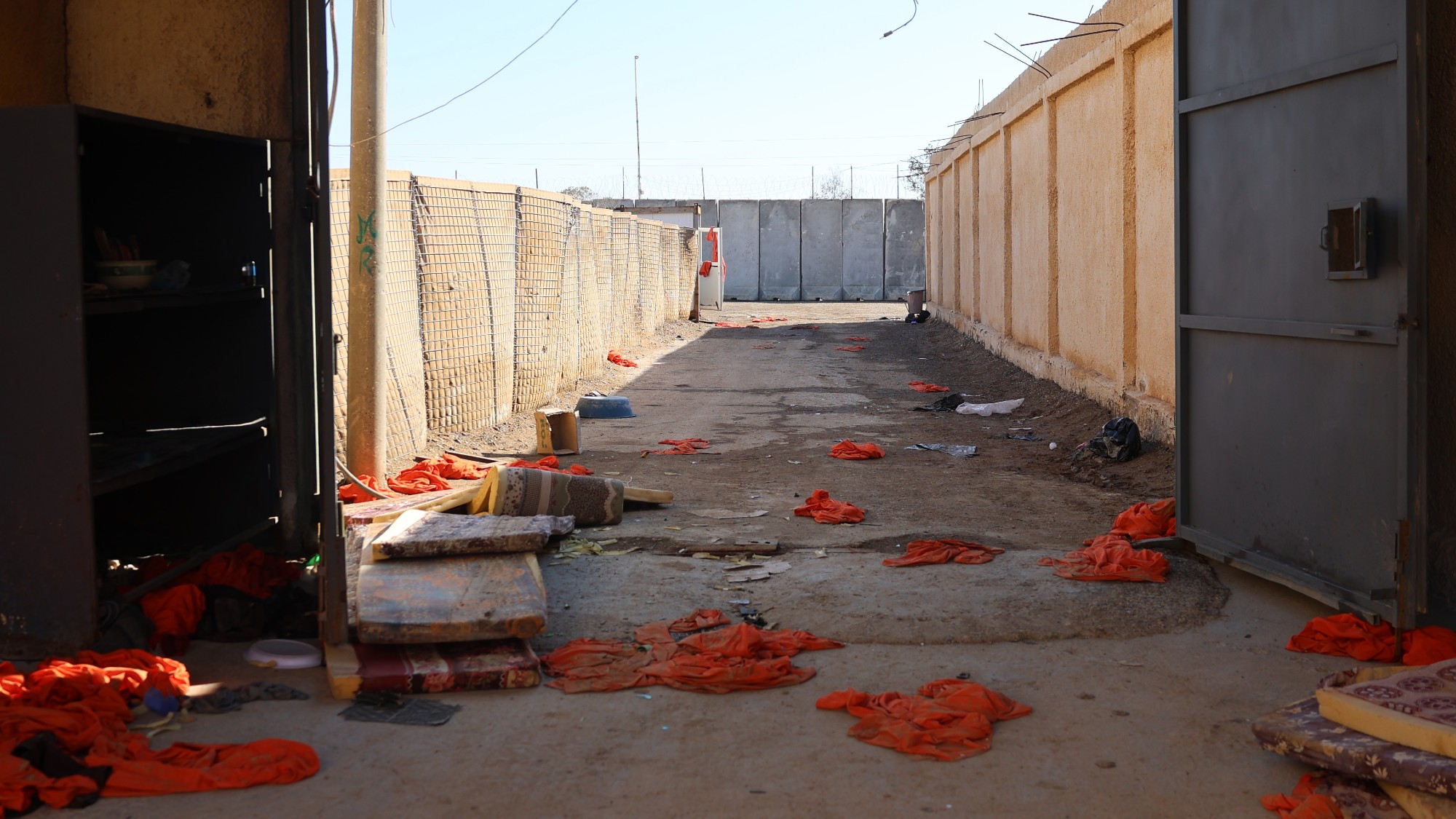 Orange jumpsuits worn by detainees are seen scattered around the prison after they were removed and discarded during the escape of Islamic State members released by SDF