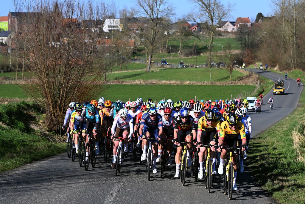 The peloton races through the Belgian countryside during the 2022 Omloop Het Nieuwsblad