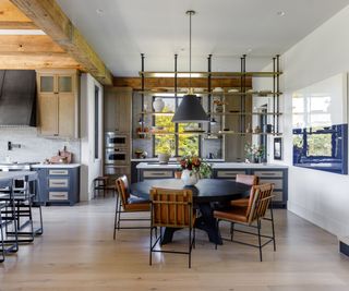 Industrial style kitchen with wooden beams and wooden cabinets with steel countertops