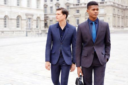 2 men in suits walking