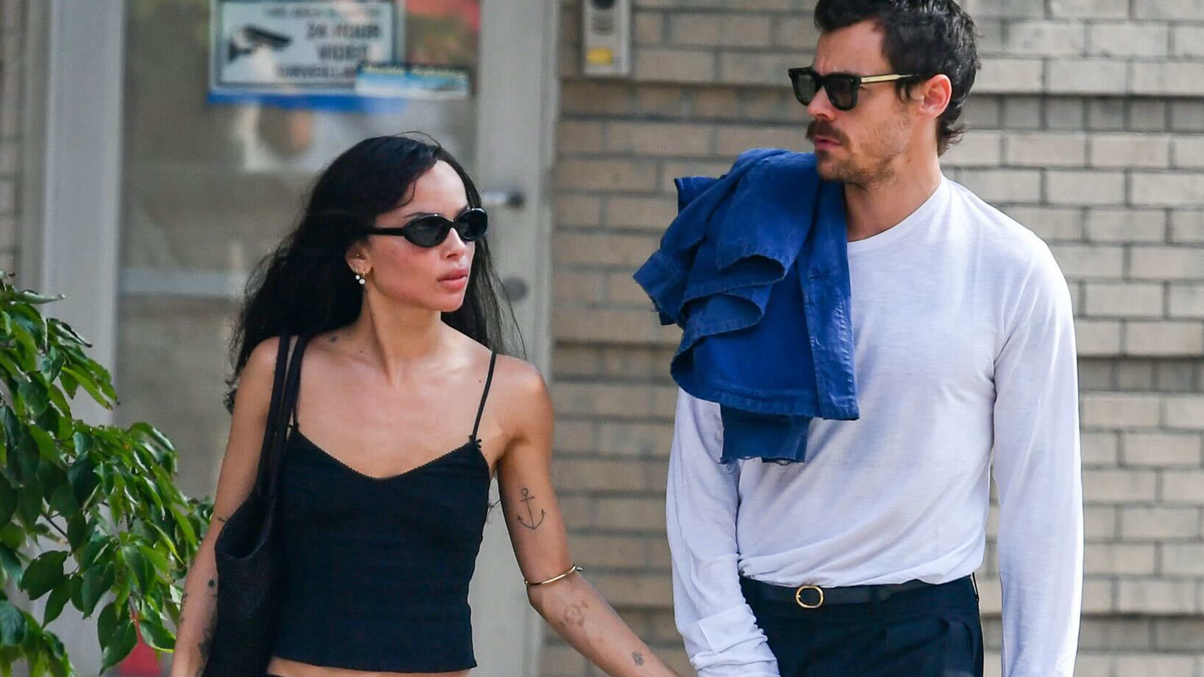 Zoe Kravitz and Harry Styles walking in New York City. Zoe is wearing a Cou Cou Intimates camisole and black knee-length skirt. 
