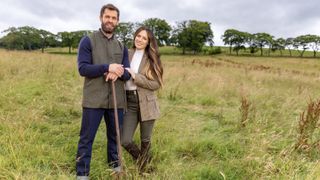 Kelvin and Liz Fletcher stand in a field in Fletchers' Family Farm.