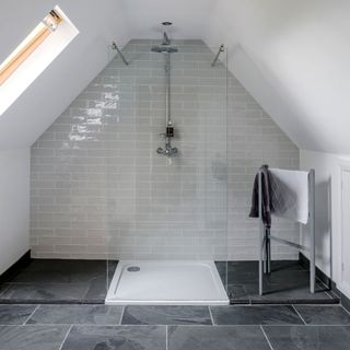 bathroom with white tiled walls and shower on wall