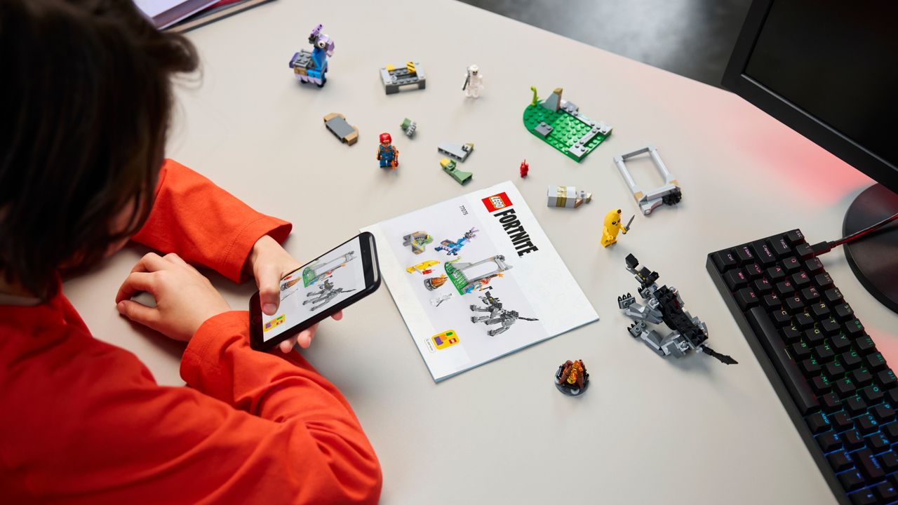 Lego Peely &amp; Sparkplug&rsquo;s Camp being constructed by a person look at instructions on their phone