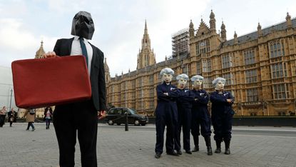 Protesters dressed as Philip Hammond and Theresa May outside parliament ahead of last week's budget