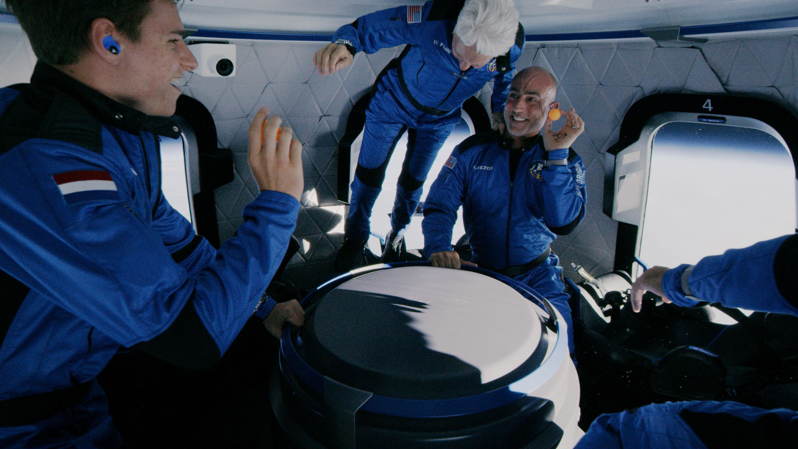 Wally Funk, Mark Bezos and Oliver Daemen enjoying themselves during the microgravity phase of Blue Origin's first crewed flight.
