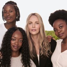 Charlize Theron with Siphosihle, Miché and Onesimo, three of the students attending university thanks to the scholarship program created by CTAOP