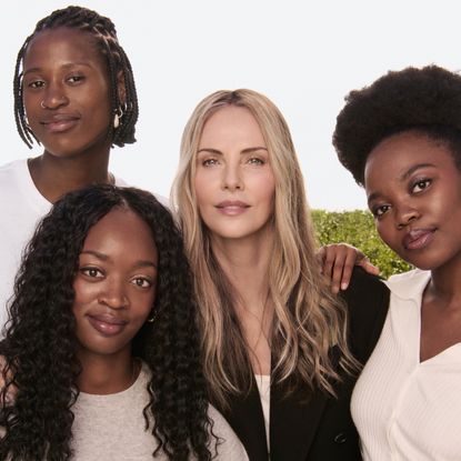 Charlize Theron with Siphosihle, Mich&eacute; and Onesimo, three of the students attending university thanks to the scholarship program created by CTAOP