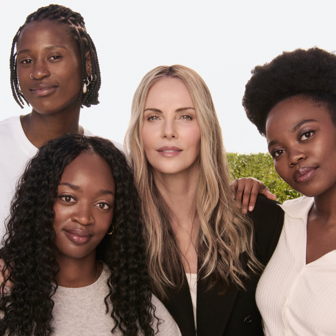 Charlize Theron with Siphosihle, Mich&eacute; and Onesimo, three of the students attending university thanks to the scholarship program created by CTAOP