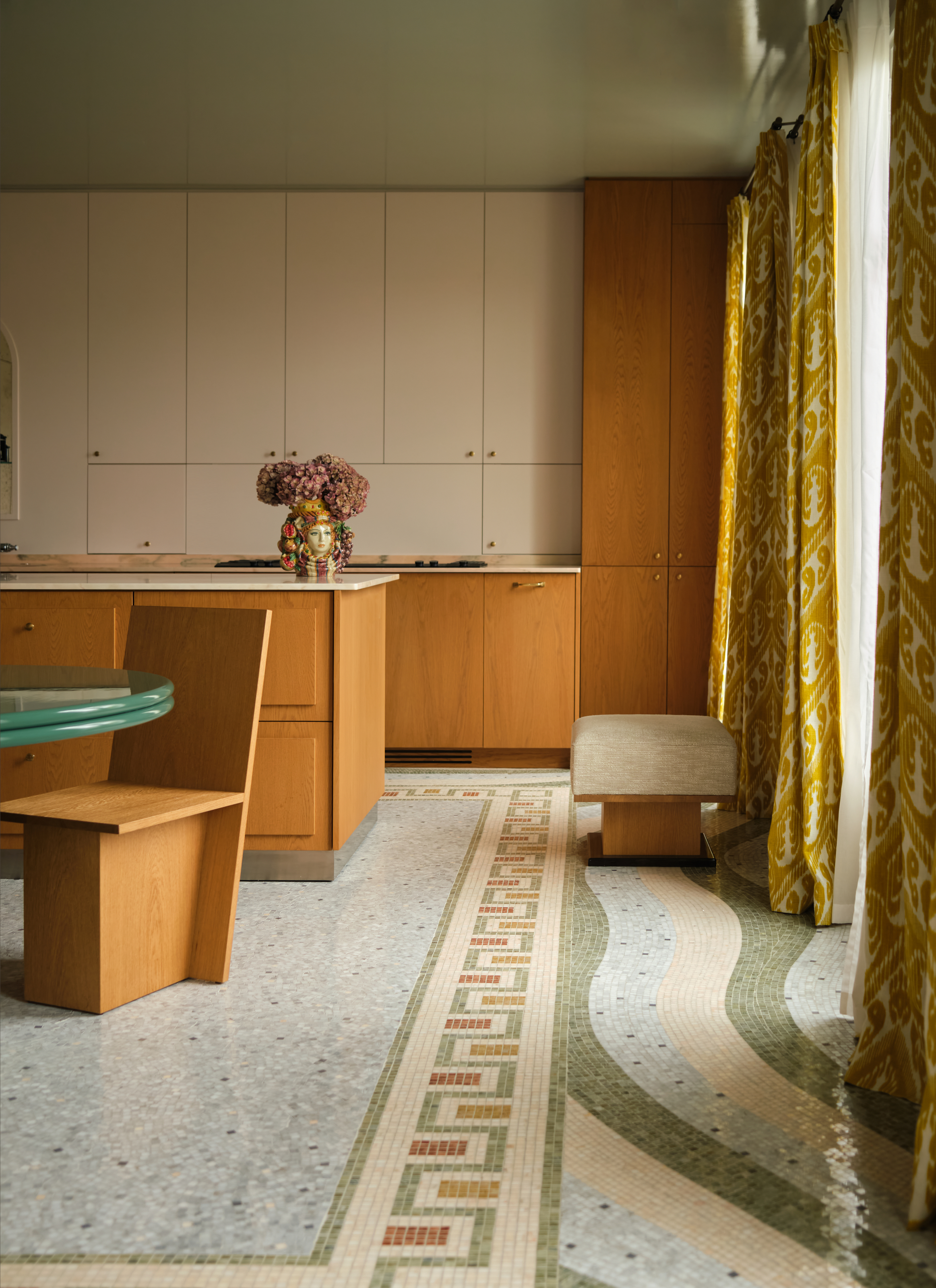 Oak wood kitchen with cream upper cabinets, mosaic tiled floor