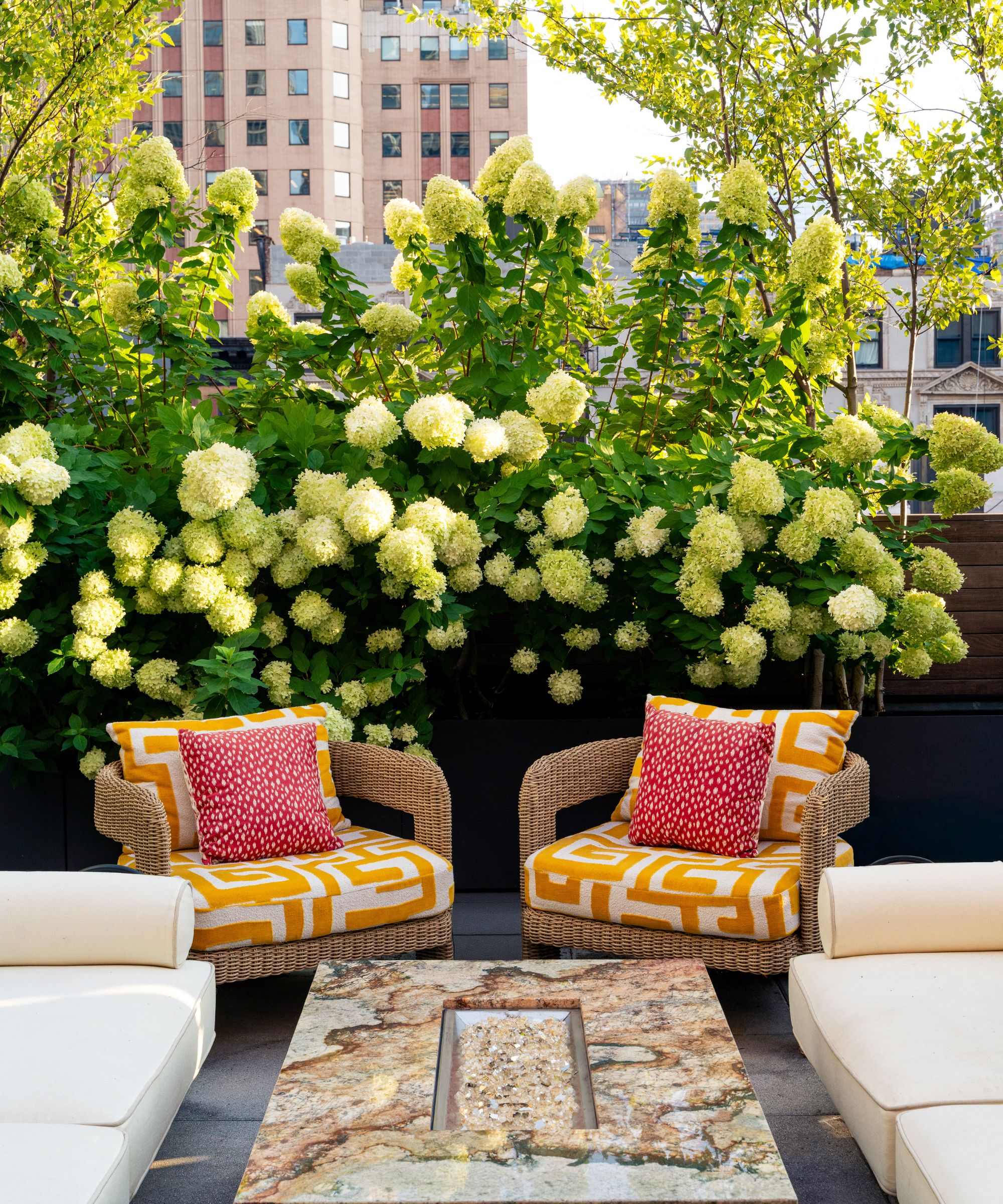 Balcony with marble coffee table and patterened statement armchairs