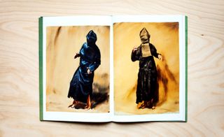 Inside the catalogue shows us two paintings of figures dressed in black robes and a black hood drawn over their head so that we can't see their faces. The figures are dancing in a ritualistic way.
