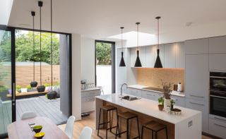 small modern kitchen extension with rooflight and sliding doors