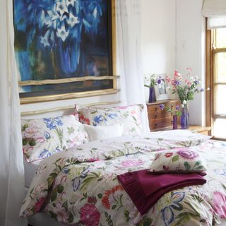 bedroom with white wall and floral printed bedding set
