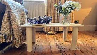 DIY cream table with china set on with wooden floorboards