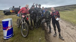 Riders sharing sausages at a red bull feed station mid enduro race