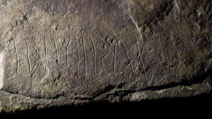 A close-up image of a piece of sandstone with etchings.