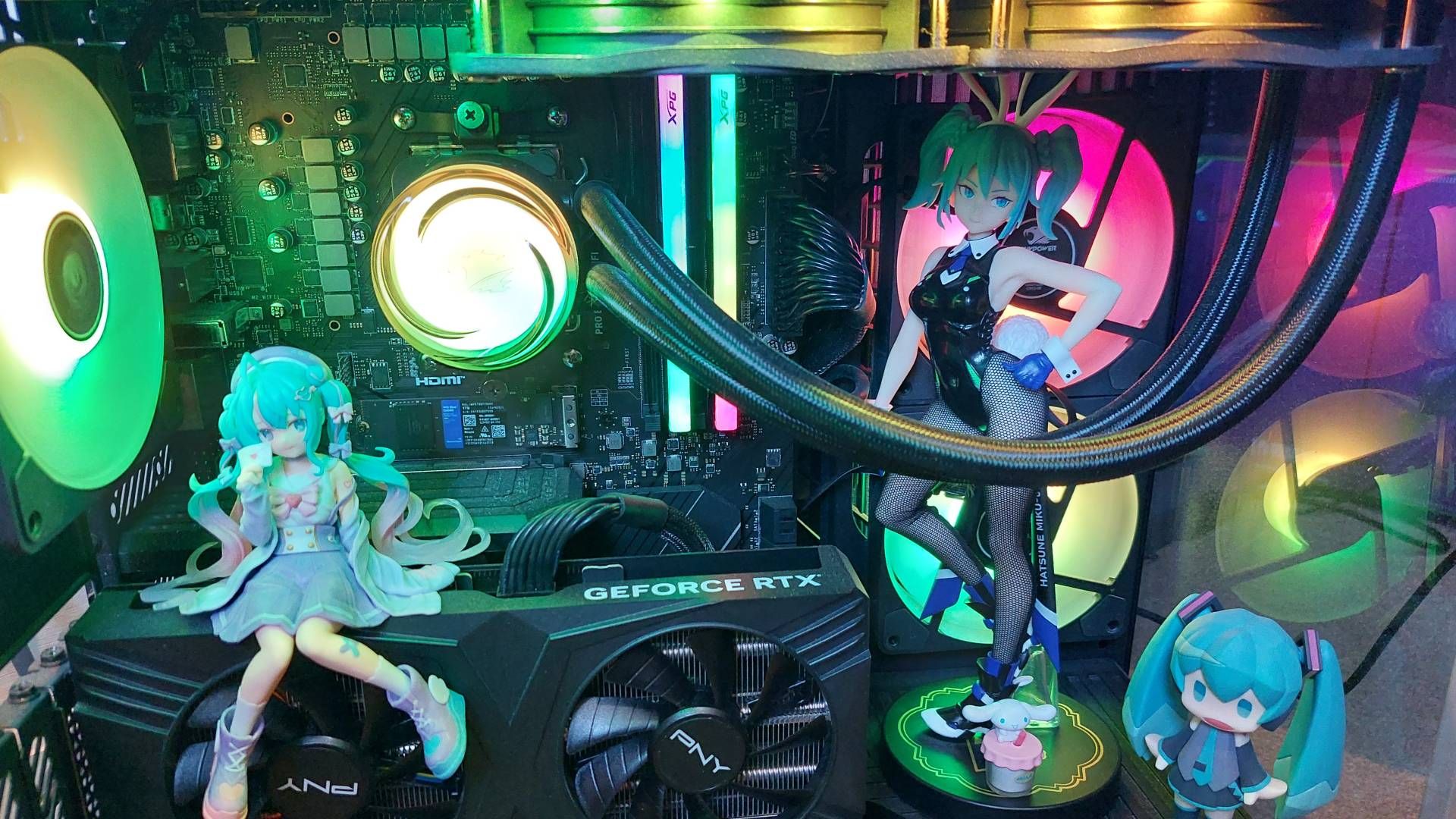A PC with many anime figures placed inside. It looks quite crowded and impractical. The RGB lighting really makes it pop though.