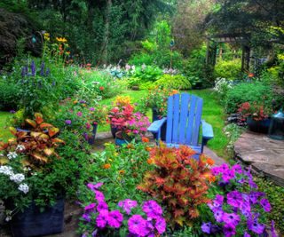 Bright flowers in pots and beds surround stone patios.