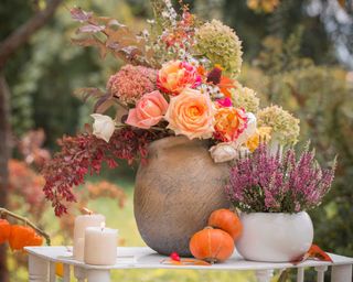 autumn themed flower arrangements on an outdoor table
