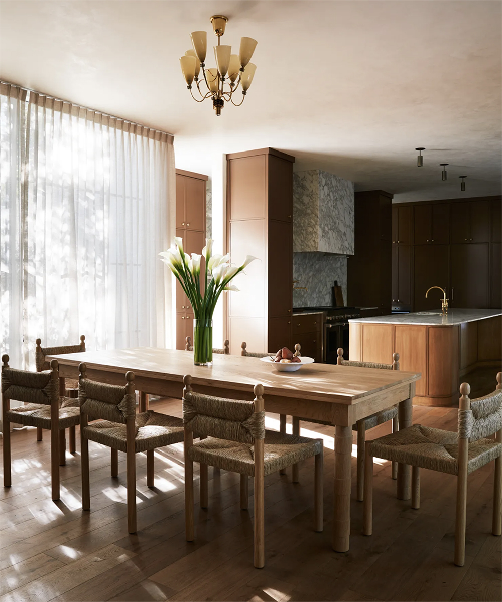 dining table with white lilies in a vase on it