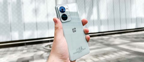 The OnePlus Nord 2T, held in hand with the back facing the camera