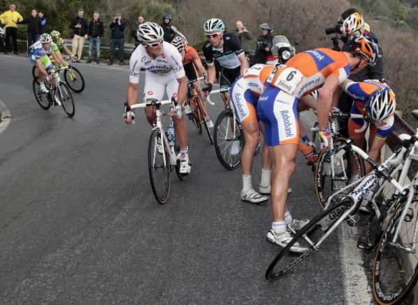 Oscar Freire is assisted by his Rabobank teammates following his crash on the descent of Le Manie.