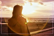 When does it get lighter illustrated by woman looking at sunrise