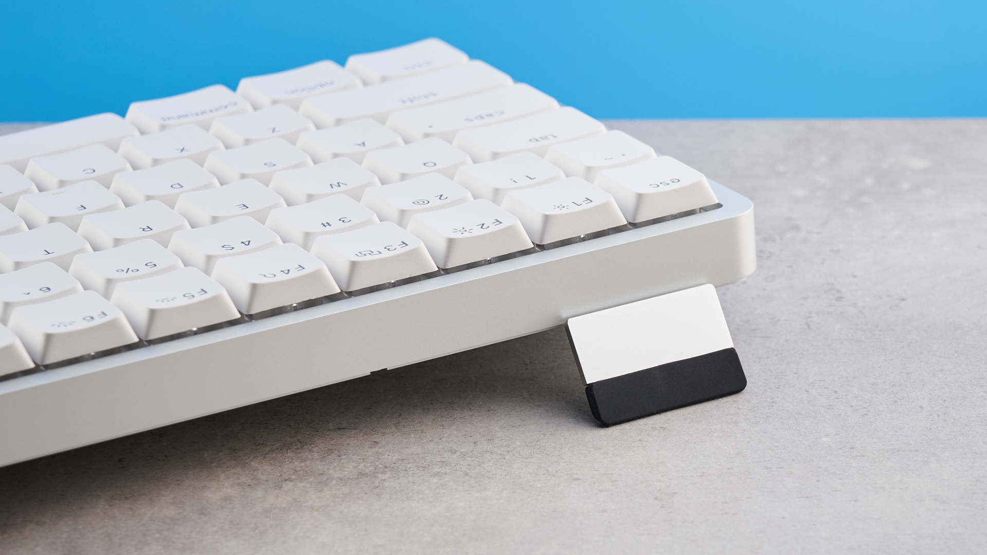 The Lofree Flow 2 on a stone surface with a blue background