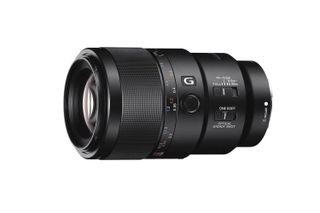 A black Sony FE 90mm f/2.8 Macro G OSS lens