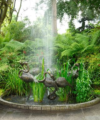 bronze sculptures in pond with fountain