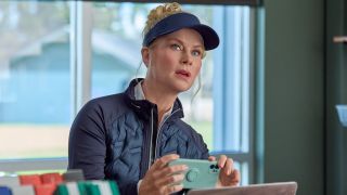Alison Sweeney takes a photo of something during an investigation on Hallmark's Best Served Cold: A Hannah Swensen Mystery.