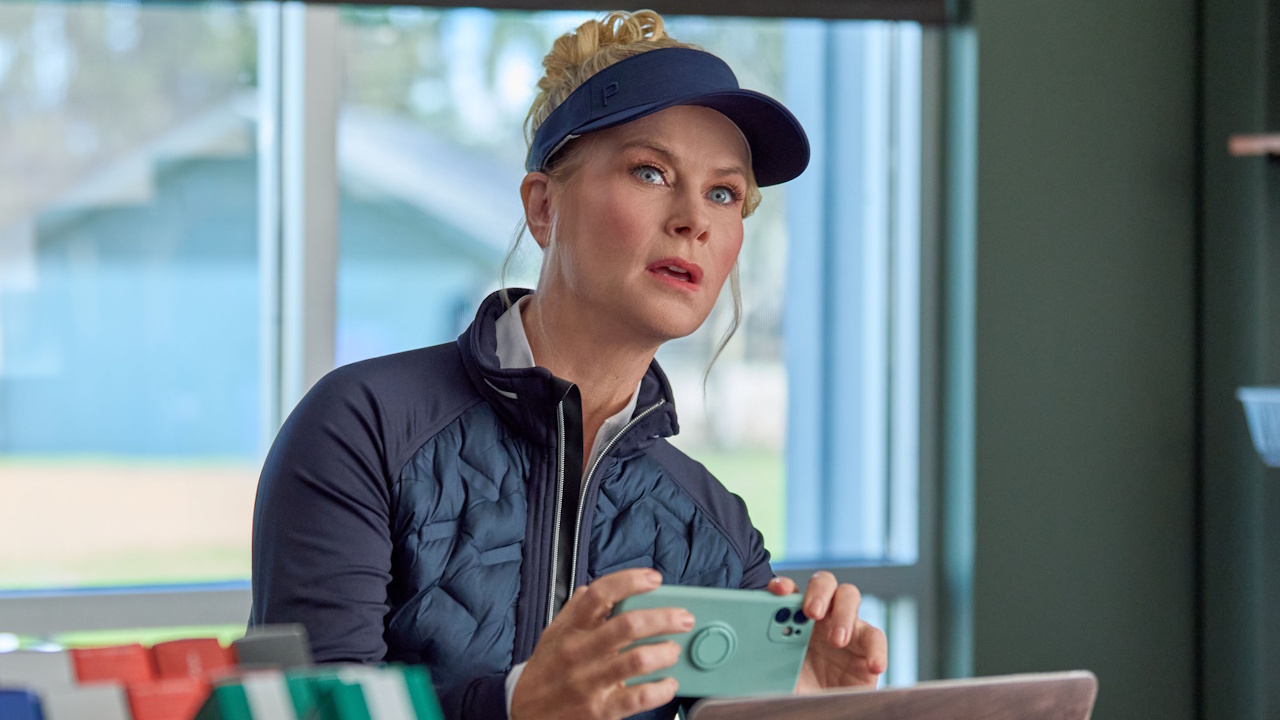 Alison Sweeney takes a photo of something during an investigation on Hallmark's Best Served Cold: A Hannah Swensen Mystery.