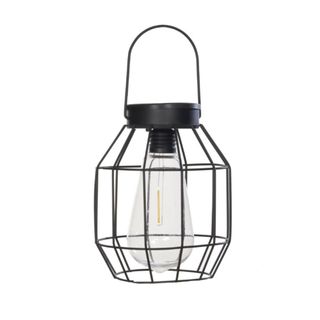 A black metal grid lantern with a curved black handle and a white lightbulb inside it