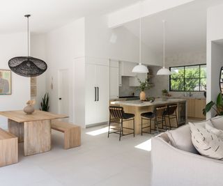 open plan kitchen dining room and living room with pale neutral furnishings