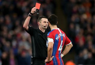Luka Milivojevic was shown a red card by referee Michael Oliver after using the pitchside monitor